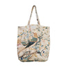 A canvas tote bag featuring a vintage-style botanical and bird print on a cream background, with two shoulder straps.