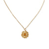 Gold necklace with an amber flower pendant on a white background