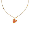 Gold tone necklace with amber beads and pendant shaped like tulip flower on a white background. 