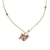 Gold tone necklace with purple gemstone beads and tulip flower shaped pendant in purple on a white background.
