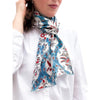 Woman wearing a floral patterned scarf on a white background