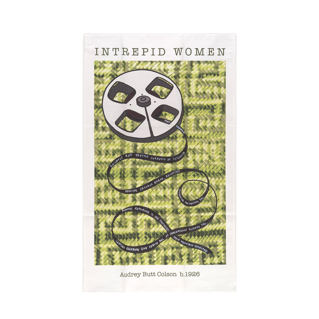 Audrey Butt Colson tea towel with an old film roll on an olive green weaved background