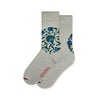 Pair of cream and grey coloured cotton socks with floral pattern in the Iznik pottery style on a white background.