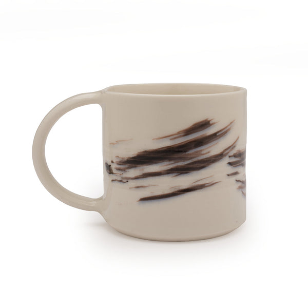 White mug with black brushstroke design against a white background