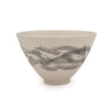 White porcelain bowl with delicate black abstract design against a white background