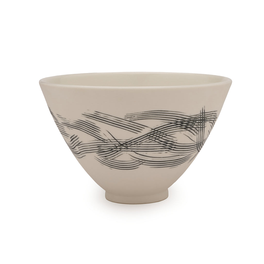 White porcelain bowl with delicate black abstract design against a white background