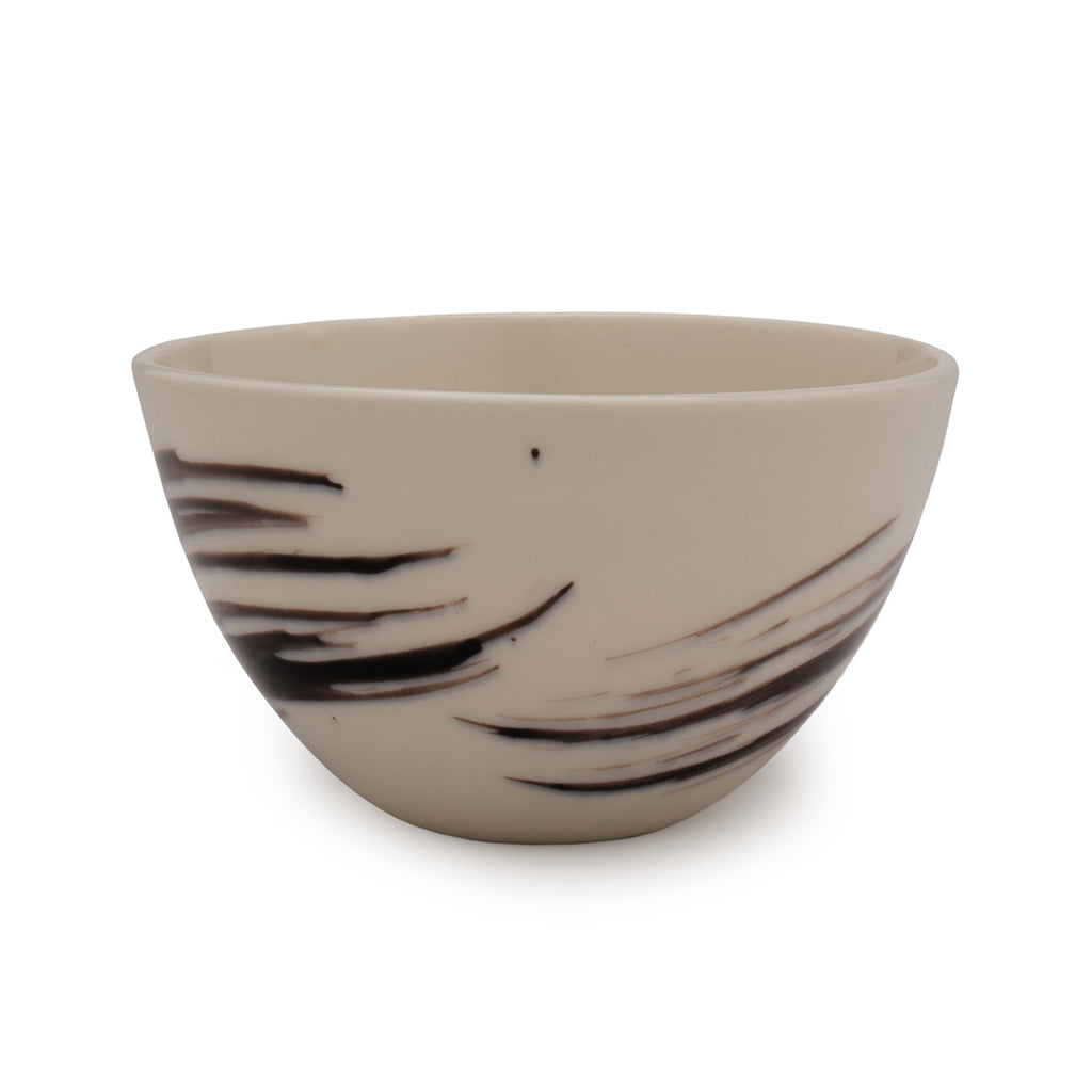 White porcelain bowl with black brushstroke patterns against a white background