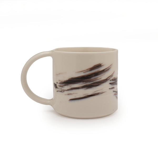 White mug with black brushstroke design against a white background