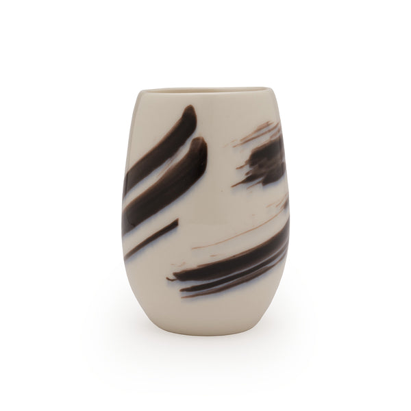 White porcelain vase with black brushstroke patterns against a white background