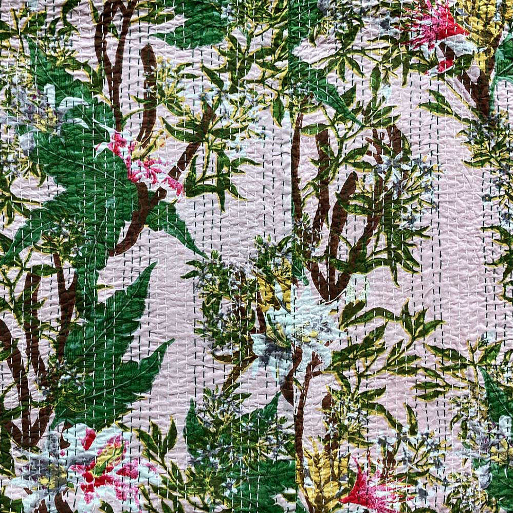 Patterned fabric with green leaves and pink flowers on a white background