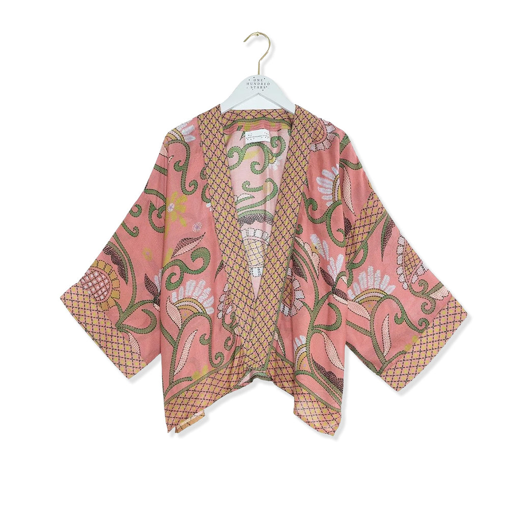Pink and green floral design kimono with Indian kantha stitching design around edges and sleeves on a white background.
