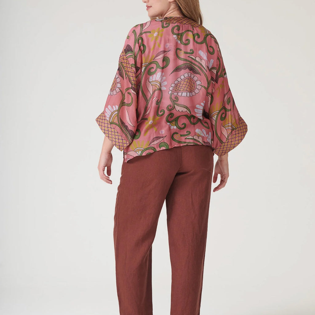 Model turned around to show back of pink and green floral Indian kantha style kimono 