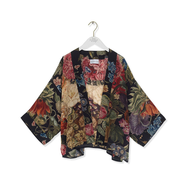 Floral patterned kimono on a white hanger against a white background