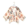 Neutral tone kimono with perfume bottles, fish and flowers art pattern on a white background.