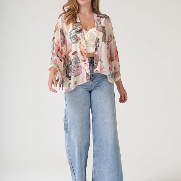 Model wearing perfume bottles kimono on a white background. 