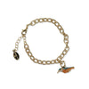 Gold chain bracelet with a bird charm on a white background
