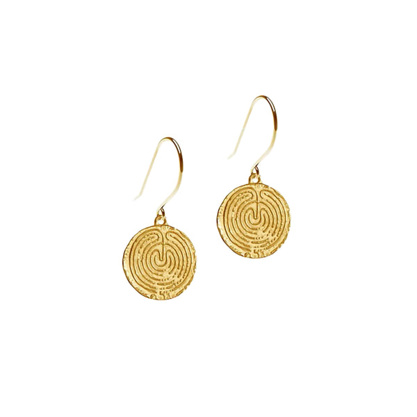 A pair of gold-coloured coin-shaped earrings with intricate labyrinth spiral patterns, suspended from gold hooks.