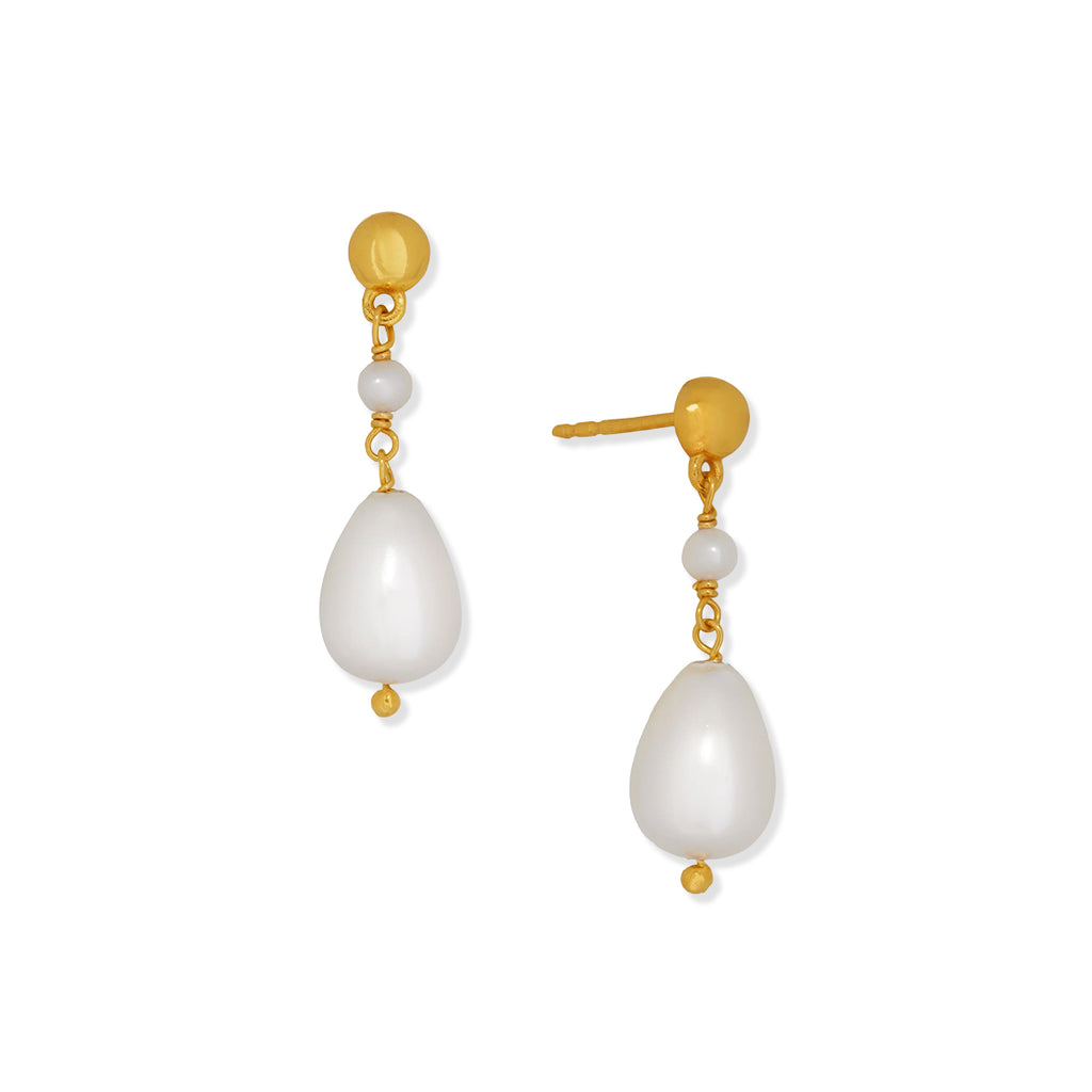 Gold pearl drop earrings on a white background.