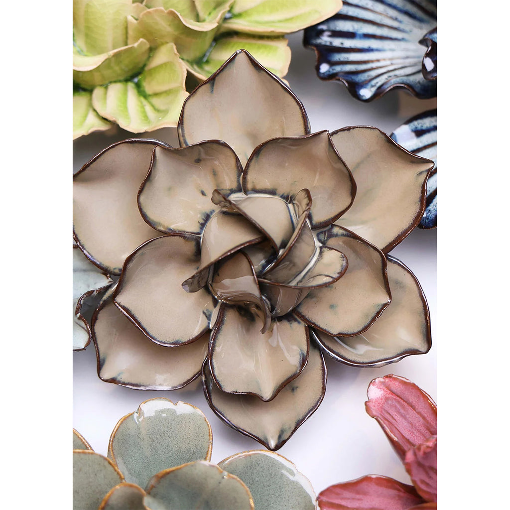 Close-up of ceramic flowers with detailed glaze patterns.