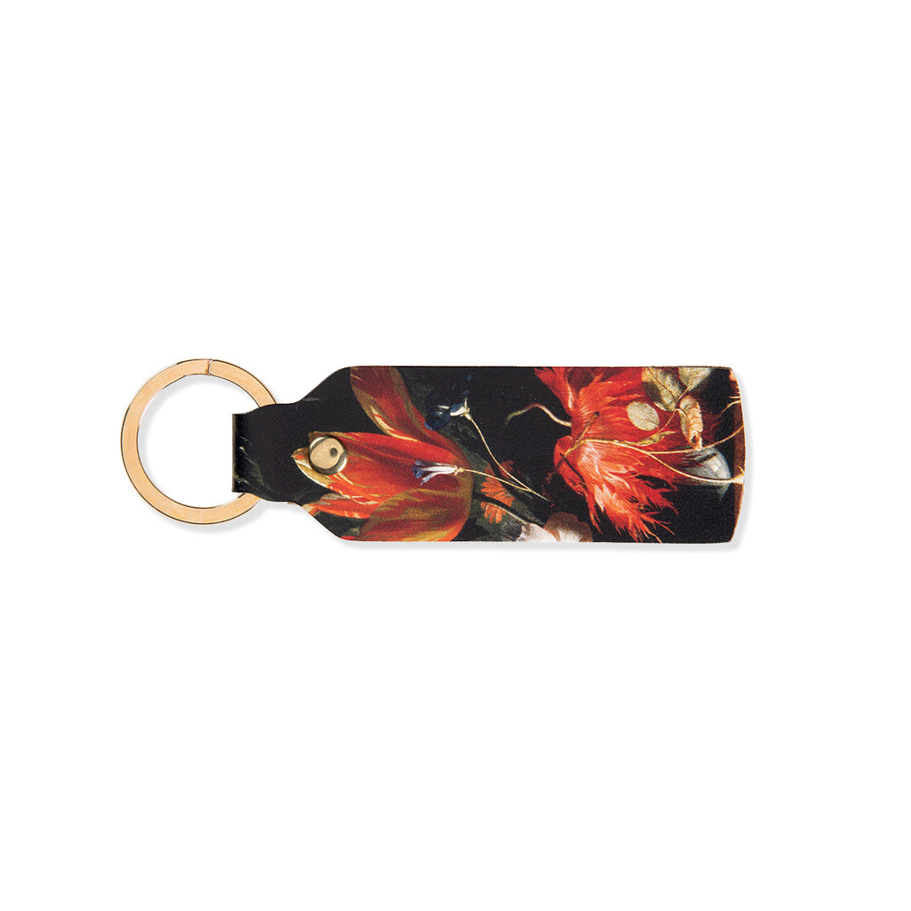 Leather keychain with a colourful floral design on a black background