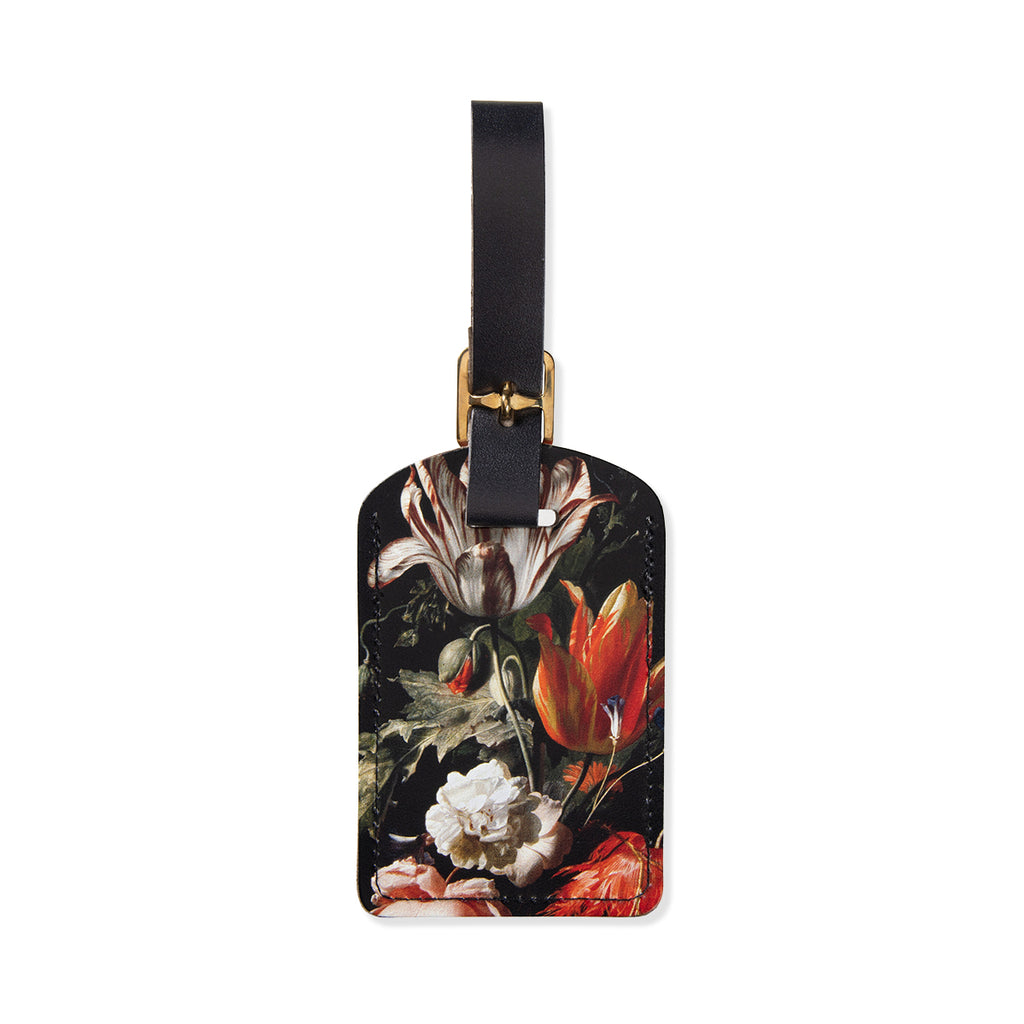 Floral-patterned luggage tag with a black strap on a white background