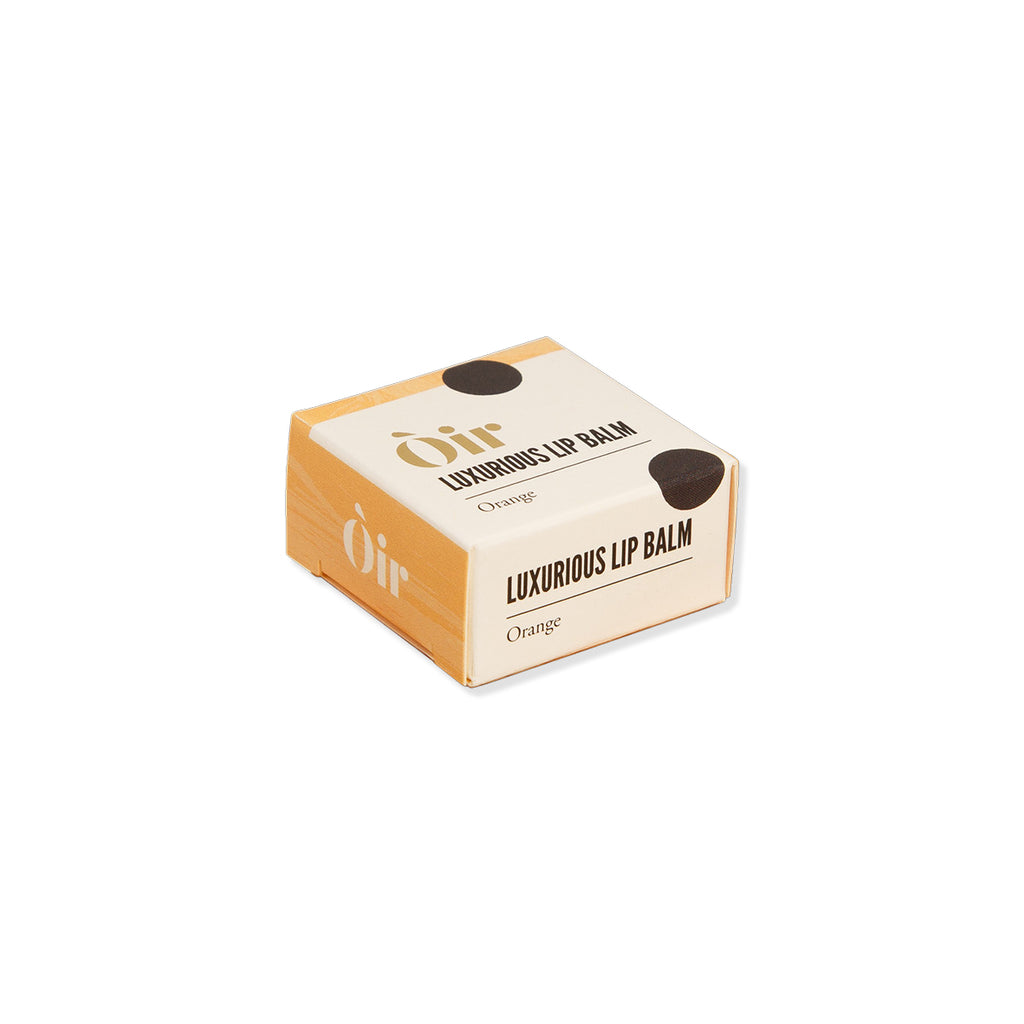 Luxurious lip balm packaging with 'oir' branding on a white background
