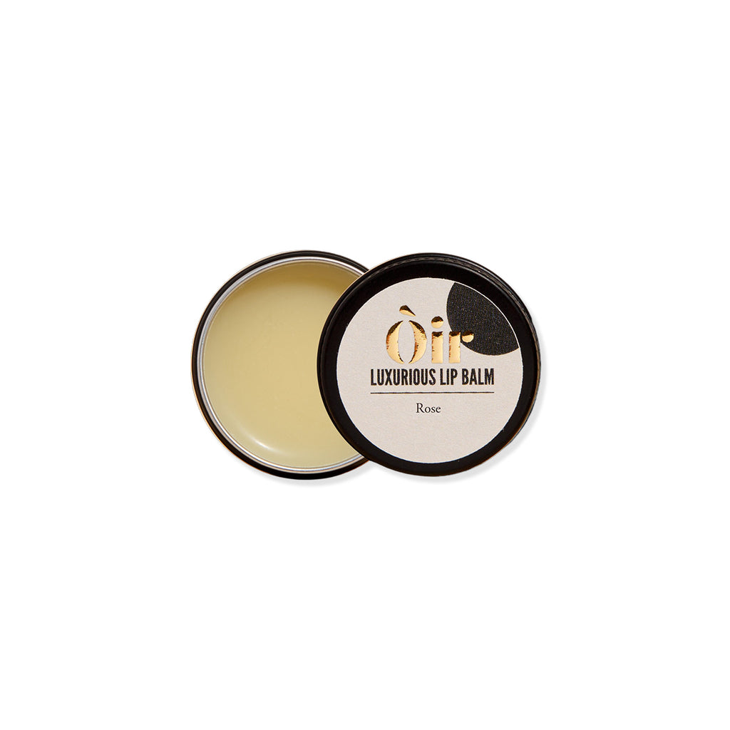 Luxurious lip balm with black lid and visible brand name on a white background