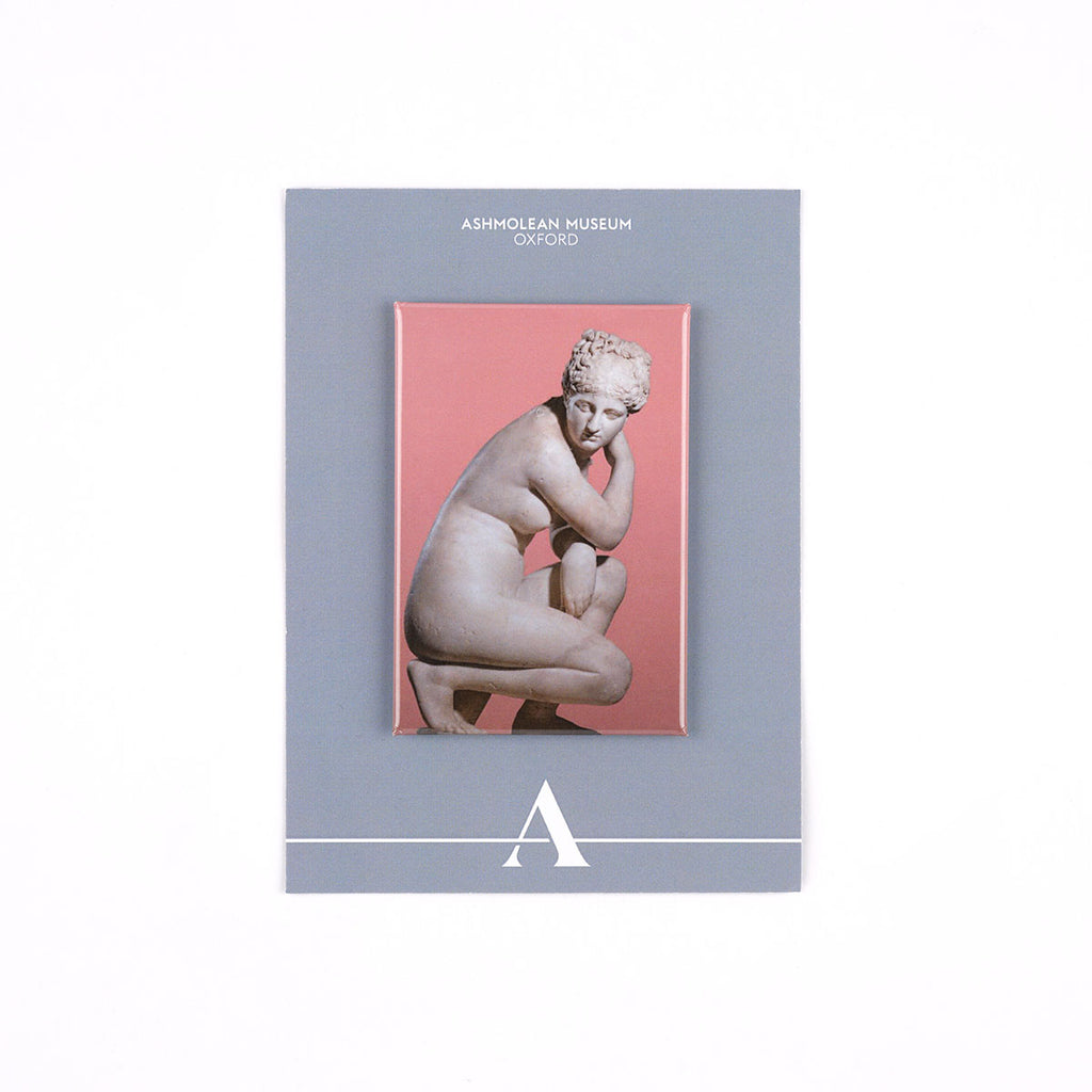 A rectangular Ashmolean Museum decorative fridge magnet with a grey border, featuring a central print of a classical crouching statue against a pink background.