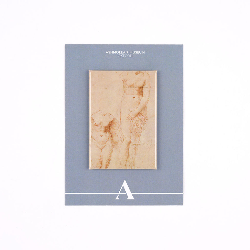 A rectangular decorative fridge magnet featuring a sepia sketch of classical figures mounted on a slate blue card. The card has white text reading 'ASHMOLEAN MUSEUM OXFORD' at the top and a white stylized letter 'A' Ashmolean Museum logo at the bottom.