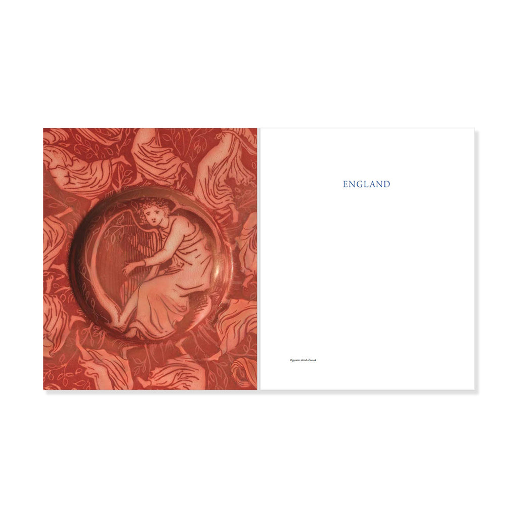 Close up of red decorative ceramic artwork and 'ENGLAND' text on a white background