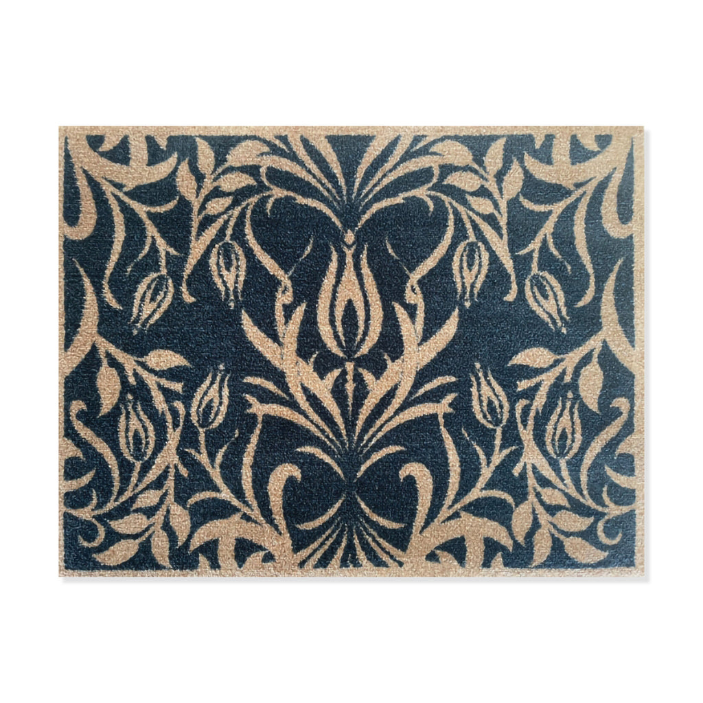 Blue and cream coloured floor mat with intricate floral design by artist May Morris on a white background.