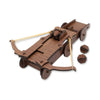 A wooden medieval crossbow toy with a dark brown wood-grain finish, light tan rubber bands, and two small loose wooden projectile components on a plain white background.