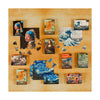 Display photo showing different mini sized jigsaws and their colourful pieces of famous artworks such as van Gogh sunflowers, girl with pearl earring, starry night and great wave displayed on gold background.