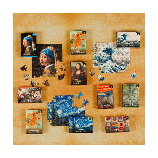 Display photo showing different mini sized jigsaws and their colourful pieces of famous artworks such as van Gogh sunflowers, girl with pearl earring, starry night and great wave displayed on gold background.