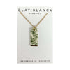 Necklace with a rectangular pendant featuring greenery on a Clay Blanca Ceramics card.