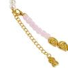 Close-up of a beaded bracelet with pale pink round beads, white pearl-like beads, gold-tone chain extender, and gold-tone decorative end pieces on a white background.