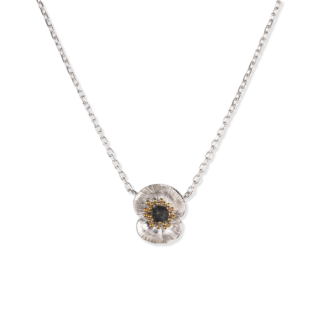 Silver poppy flower necklace with poppy flower pendant with oxidised silver and 22ct gold plated accents on a white background.