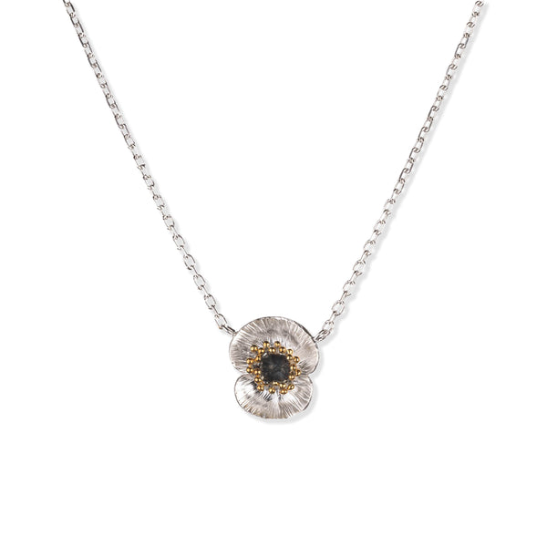Silver poppy flower necklace with poppy flower pendant with oxidised silver and 22ct gold plated accents on a white background.