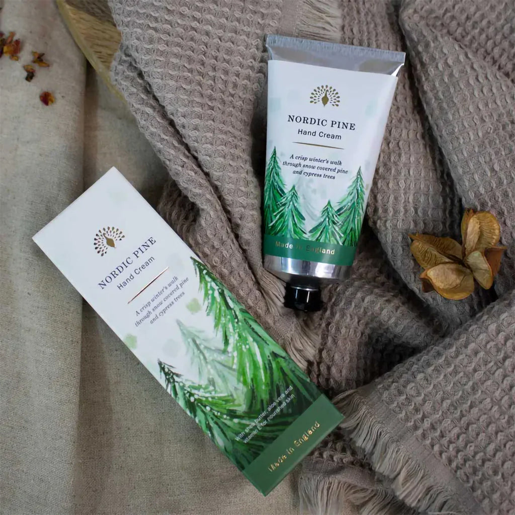 Nordic Pine hand cream and packaging on a textured fabric background