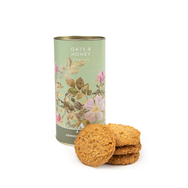 Oats & Honey biscuits with a decorative canister on a white background