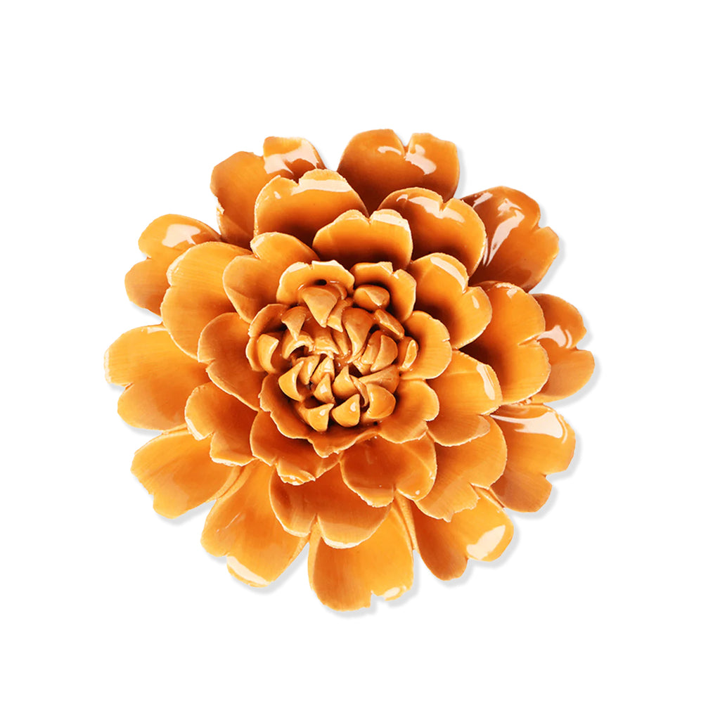 Orange flower-like decorative item on a white background