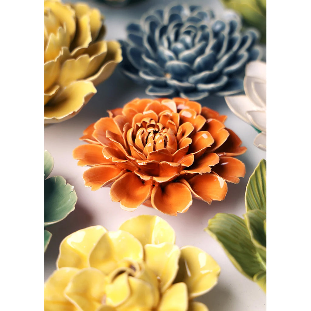 Colorful ceramic flowers on a white background