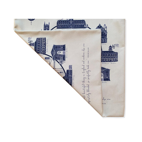 Two folded fabric panels from oxford mapped tote bag with architectural design and text on a white background