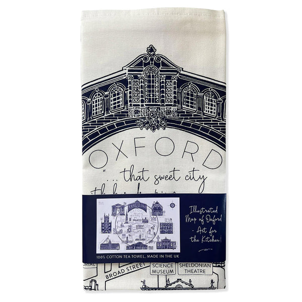 Tea towel with navy blue and white design of Oxford architecture and text.