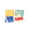 An assortment of 4 coloured soaps