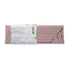 Pink leather pencil case envelope with a label on a white background