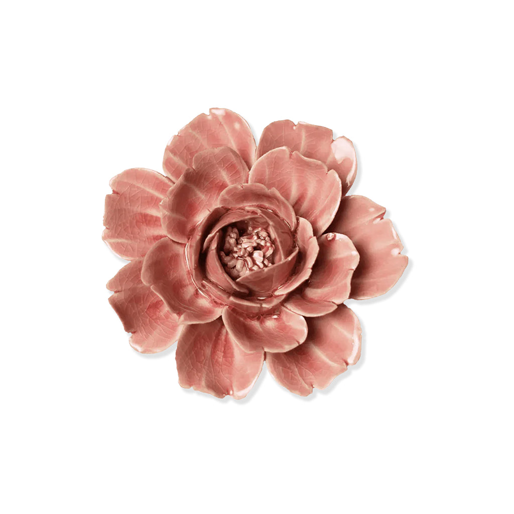 Pink ceramic rose flower on a white background.