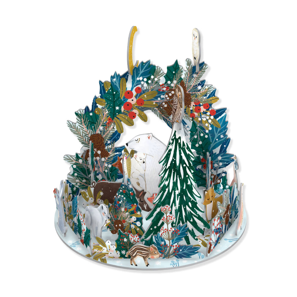 3D Advent calendar creating wintry wildlife scene of polar bear with cub in centre surrounded by other animals in snowy woodland