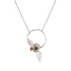 Necklace with a circular pendant featuring poppy leaves and a small gemstone beads on a white background