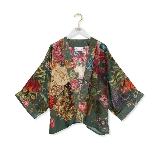Green Kimono with floral pattern on a hanger against a white background.